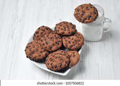 chocolate oatmeal cookies on a white background with milk