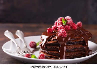 Chocolate pancake with chocolate glaze,raspberries and mint.selective focus - Shutterstock ID 388319164