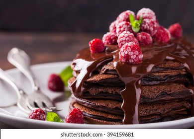 Chocolate pancake with chocolate glaze,raspberries and mint.selective focus - Shutterstock ID 394159681