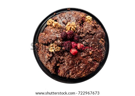 chocolate pie with blueberries, strawberries, walnuts on a white background (isolate)