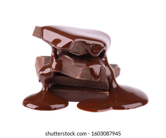 Chocolate pieces stack and chocolate syrup isolated on white background. Close up.