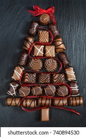 Chocolate Pralines Christmas Tree On Stone Black Table