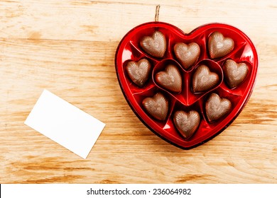 Chocolate Pralines In Red Heart Shape Box On Table