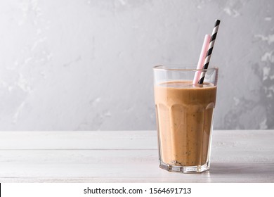 Chocolate Protein Shake On A White Wooden Background. Fresh Milkshake With Blueberry On A Light Table. A Glass Of Chocolate Smoothie .