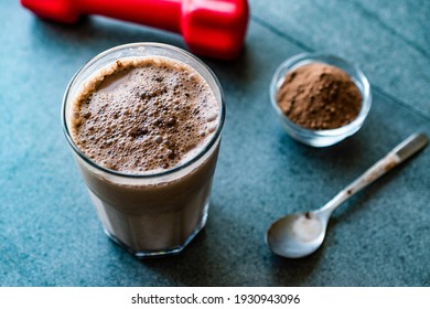 Chocolate Protein Shake Smoothie with Whey Protein Powder and Red Dumbbells. Sports Drink. Sporty Bevergae.