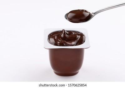 chocolate pudding brown cup plastic  with spoon isolated on white background
