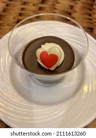 Chocolate Pudding In A Single Serving Glass Cup Topped With Butter Cream Frosting And A White Chocolate Heart. Valentine's Day Dessert.