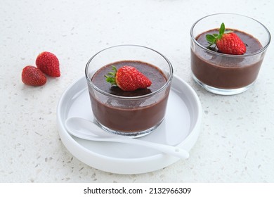 Chocolate pudding with strawberries in glass on white table. - Powered by Shutterstock