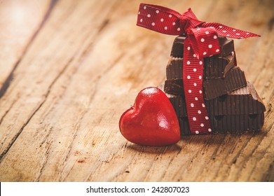 Chocolate with ribbon and heart on St. Valentine's day love.