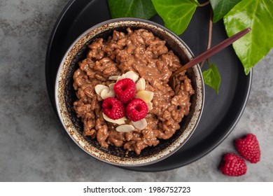 Chocolate Rice Porridge With Raspberries And Almonds. Top View.