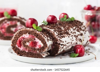 Chocolate roll cake with cream and cherries. Summer dessert  with berries - Powered by Shutterstock