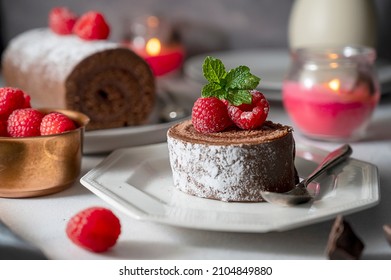 Chocolate roll cake or swiss dessert cake with fresh raspberrie fruits - Shutterstock ID 2104849880