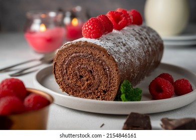 Chocolate roll cake or swiss dessert cake with fresh raspberrie fruits - Shutterstock ID 2154846161