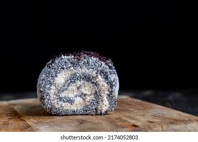 Chocolate Roll With A Creamy Curd Layer In Coconut Chips, A Roll Of Cakes And Cottage Cheese Cut Into Pieces