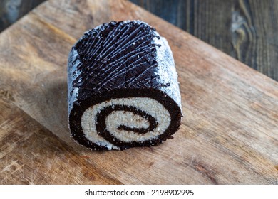 Chocolate Roll With A Creamy Curd Layer In Coconut Chips, A Roll Of Cakes And Cottage Cheese Cut Into Pieces