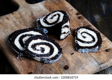 Chocolate Roll With A Creamy Curd Layer In Coconut Chips, A Roll Of Cakes And Cottage Cheese Cut Into Pieces