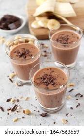 Chocolate smoothie with banana and nuts. Protein smoothie. Top view with copy space.