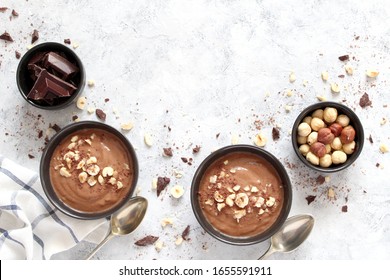 Chocolate smoothie with banana and nuts. Protein smoothie. Healthy eating. Top view with copy space.