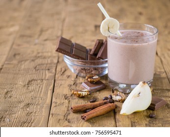 Chocolate smoothie with banana and pear on vintage rustic table. The concept of healthy sports nutrition.