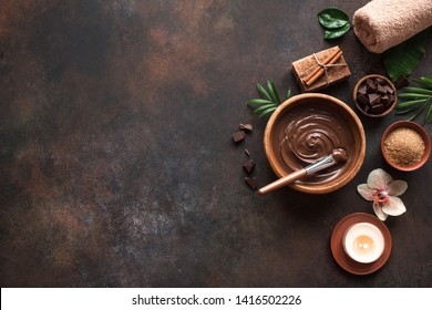 Chocolate Spa flat lay on dark background, top view. Natural spa beauty products with chocolate.