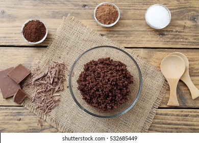 chocolate spa- homemade face and body scrub in a glass on wood background