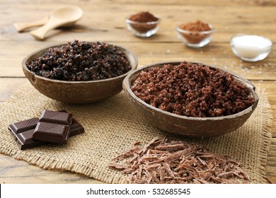 chocolate spa- homemade face and body scrub in a glass on wood background