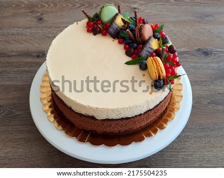 Chocolate sponge cake with dark chocolate mousee, whiskey cream mousse, sour cherries jelly and mascarpone cream frosting. Selective focus.