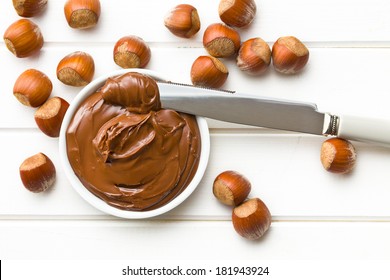 chocolate spread in bowl on wooden table