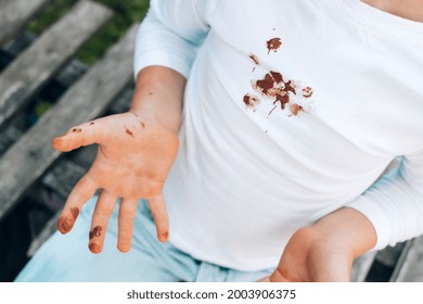 Chocolate stains on children's clothes. daily life dirty stain for wash and clean concept. top view. High quality photo - Shutterstock ID 2003906375