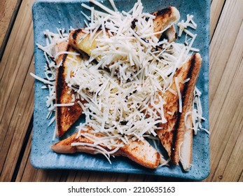 Chocolate Stuffed Toast With Cheese Sprinkles On A Blue Square Plate On A Brown Wooden Background.