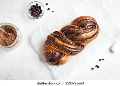 Chocolate Swirl Bread Or Brioche Bread. Homemade Sweet Desert Pastry - Chocolate Swirl Bread (Babka) On White Background, Top View, Copy Space.