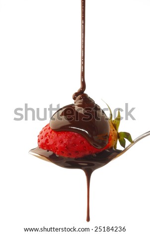 Chocolate syrup being poured onto a strawberry in a spoon