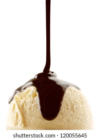 Chocolate Syrup Being Poured Over A Scoop Of Vanilla Ice Cream