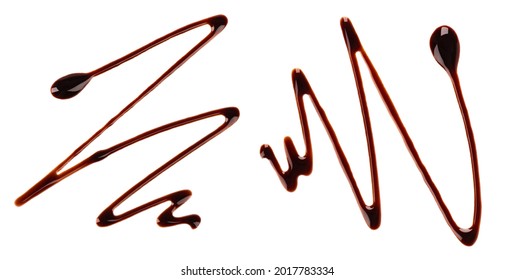 Chocolate syrup drizzle isolated on white background. Splashes of sweet chocolate sauce. Top view.