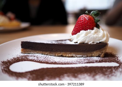 Chocolate Tart With Strawberry And Whipped Cream Decorated With Spoon Outline