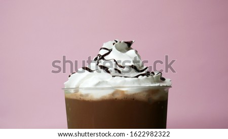 Chocolate topped whip cream Cocoa smoothie on Pink background, Food concept Front view.