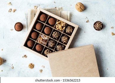 Chocolate Truffle Balls With Cocoa Powder In Blank Craft Paper Box, Sweet Delicious Gift Dessert For Winter Hoildays On Marble Background, Shallow Depth And Selective Focus