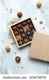 Chocolate Truffle Balls With Cocoa Powder In Blank Craft Paper Box, Sweet Delicious Gift Dessert For Winter Hoildays On Marble Background, Shallow Depth And Selective Focus