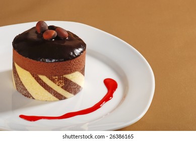 Chocolate Truffle Cake With Nuts And Raspberry Sauce