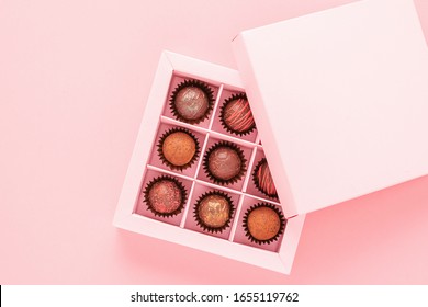 Chocolate Truffle Candies In A Box Pink Background. Gifts Festive Food Love Concept. Horizontal Frame Copy Space