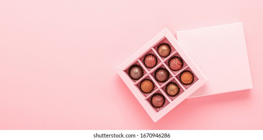 Chocolate Truffle Candies In A Box Pink Background. Gifts Festive Food Love Concept. Horizontal Frame Copy Space