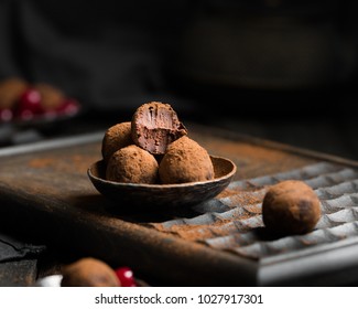 Chocolate Truffle. Dark Chocolate And Cherry Candy, Sprinkled With  Cocoa On A Dark Wooden Background In Rustic Style. Atmospheric Food Photo. 
Homemade Fresh Energy Balls.