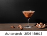 Chocolate Truffle Martini Cocktail on dark wooden background, copy space. Truffletini or Godiva cocktail recipe.