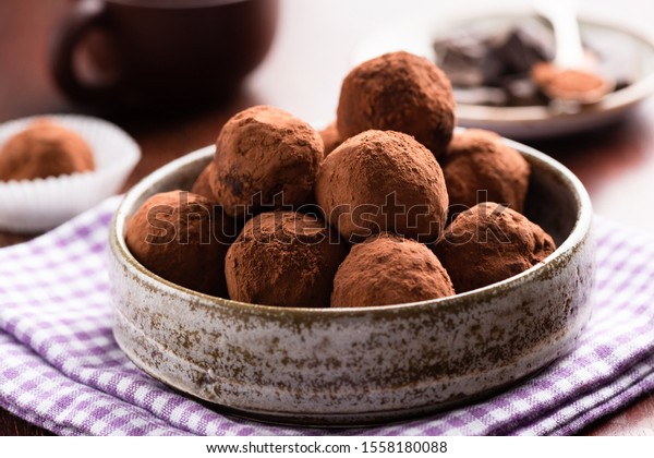 Chocolate truffles in ceramic dish on table.\
Homemade chocolate candy\
truffles