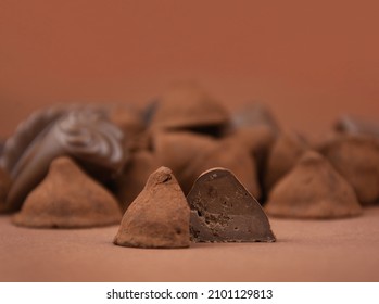 Chocolate truffles on a brown background stock images. Pile of chocolate candies isolated on a brown background stock images. Chocolate pralines close-up stock photo
