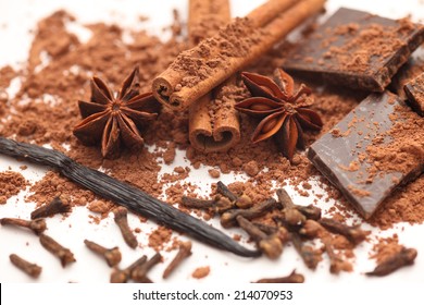 Chocolate, vanilla, cloves, star anise, and cinnamon sticks. Closeup.  - Shutterstock ID 214070953