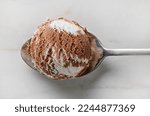 chocolate and vanilla ice cream ball in a spoon, top view