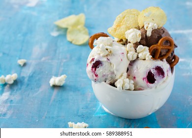 Chocolate and vanilla ice cream with berries, pretzel, salty popcorn and potato chips. Space for text