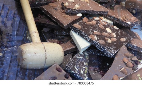 Chocolate: Various Types Of Broken Slab Chocolate And A Wooden Mallet In A Window Display Of A Chocolatier's Shop In Le Touquet, France