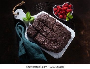 Chocolate Vegan Brownie Pie With Tahini And Fresh Raspberries On A Dark Background